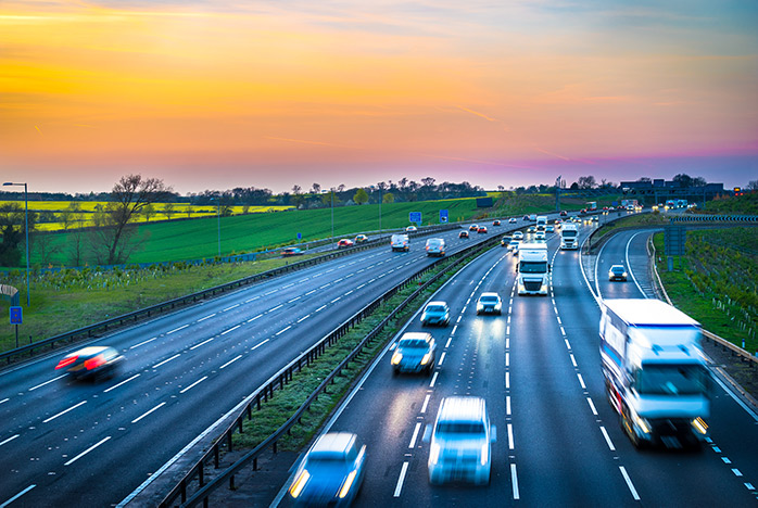 A A busy motorway with different kinds of cars and trucks